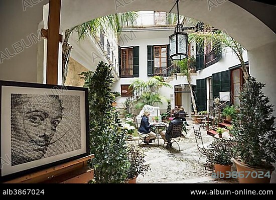 SALVADOR DALÍ. Courtyard with a café, portrait of Salvador Dali at front, Dali Museum, Palma de Mallorca, Majorca, Balearic Islands, Spain, Europe.