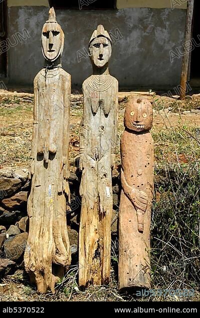 Three ancient wooden totem figures museum Konso Ethiopia.