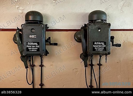 Two telephones in a bunker from the 2nd World War with inscription, the enemy is listening, in German, open-air museum Atlantic Wall, Raversijde or Raversyde, Oostende, West Flanders, Belgium, Europe.