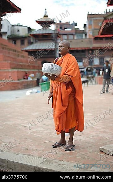 Buddhist monk begging for food on Royal Palace Square or Durbar Square, Kathmandu, Bagmati, Nepal, South Asia, Asia.