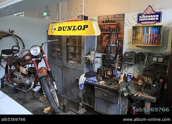 Historic motorcycle workshop, Dunlop neon sign, ErfinderZeiten: Auto- und Uhrenmuseum, Time of Innovators: Museum of Cars and Clocks, Schramberg, Black Forest, Baden Wuerttemberg, Germany, Europe.