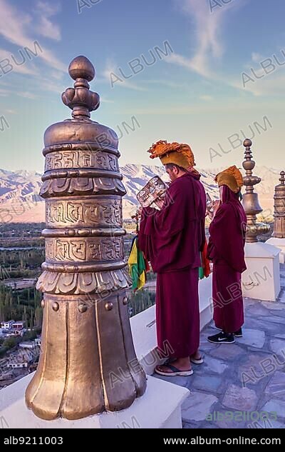 Buddhist monks blowing conch shells at Thikse Monastery (Thiksay Gompa), Ladakh, Kashmir, India, Asia.