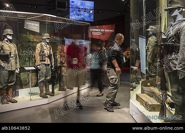 Tourists with audio guides visiting the Bastogne War Museum devoted to the Second World War Two Battle of the Bulge in the Belgian Ardennes, Belgium, Europe.