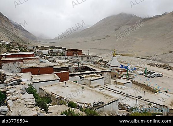 Rongbuk monastery and white stupa in front of the cloudy Mt. Everest, Tibet, China, Asia.