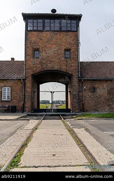 Auschwitz, Poland - 15 September, 2021: view of the gatehouse and train tracks at Auschwitz Concentration Camp in Poland.