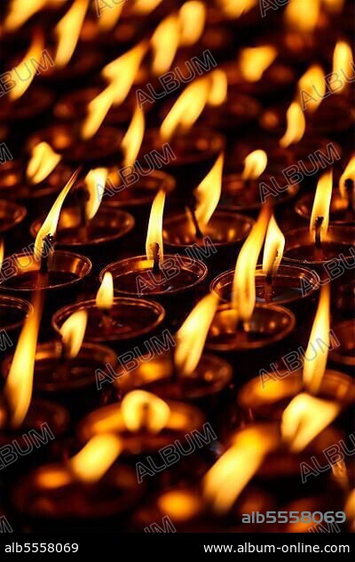 Burning candles in Buddhist temple. Dharamsala, Himachal Pradesh, India, Asia.