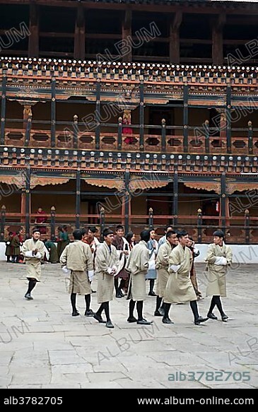 Tibetan Buddhist festival, men wearing the traditional Gho robe, Rinpung Dzong Monastery and Fortress, courtyard, Paro, Himalayas, Bhutan, South Asia, Asia.