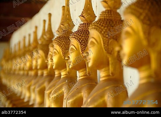 Theravada Buddhism, meditation, row of golden Buddha statues, temple, That Ing Hang Stupa, in Savannakhet, Laos, Southeast Asia, Asia.