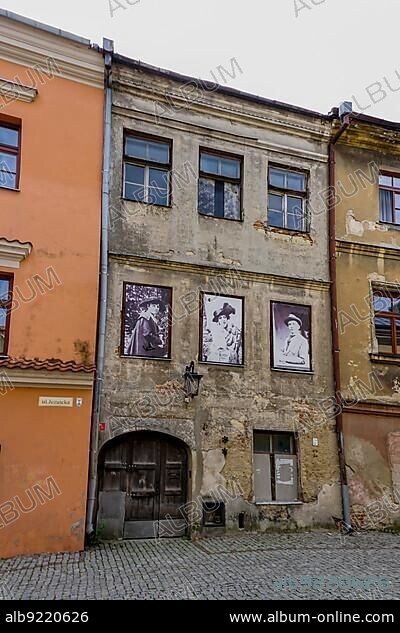 Lublin, Poland - 13 September, 2021: shabby old buildings in the historic city center of lublin with old photographs from the city's history.