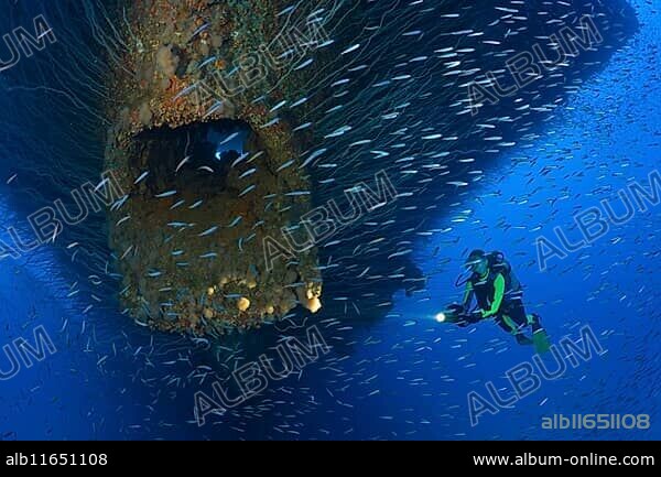 Diver at an anchor hawsehole on the bow of the USS Saratoga, Marshall Islands, Bikini Atoll, Micronesia, Pacific Ocean, Oceania.