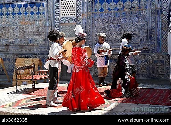 Traditional dance with clothes of Khwarezm Tash Hauli Palace Khiva Uzbekistan.