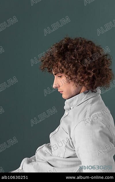 Portrait curly haired young man 10.
