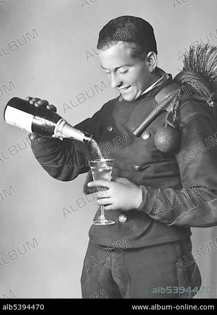 Historic photo, chimney sweep with champagne bottle, lucky charm, ca. 1920.