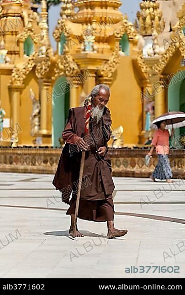 Pilgrim, Buddhist monk circling the Shwedagon Pagoda during meditation, Yangon, Myanmar, Asia.