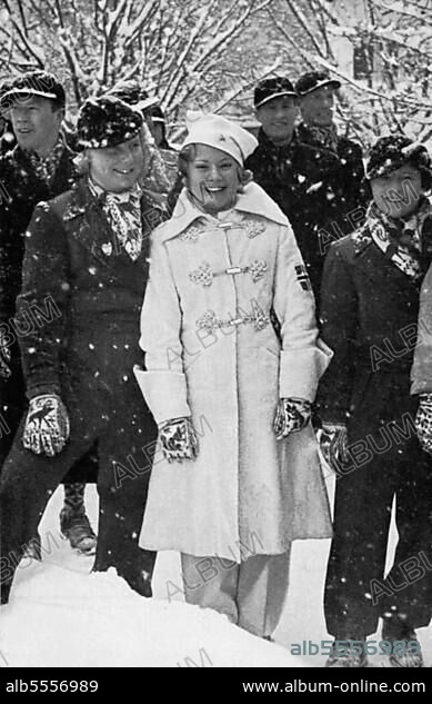 Sonja Henie, and gold medallist, waits in the snow flurry outside the stadium, which she will enter moments later with her comrades, figure skater from Norway.