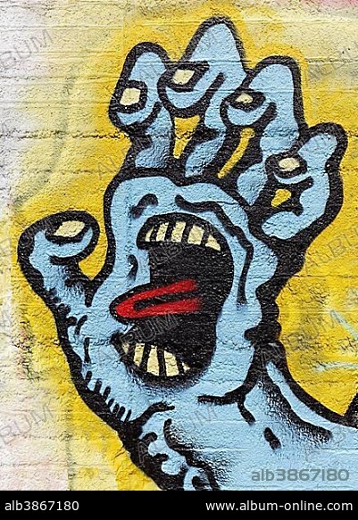 Monster hand, grasping, face in palm, tongue stuck out, symbolic, graffiti, street art, Duisburg, North Rhine-Westphalia, Germany, Europe.