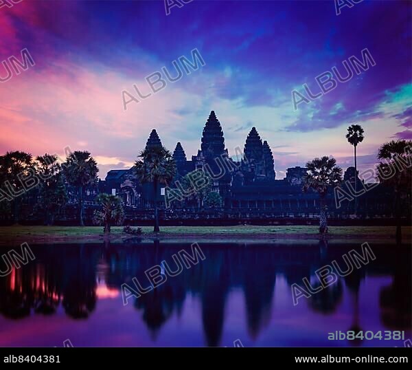 Vintage retro effect filtered hipster style image of Angkor Wat, famous Cambodian landmark, on sunrise. Siem Reap, Cambodia, Asia.