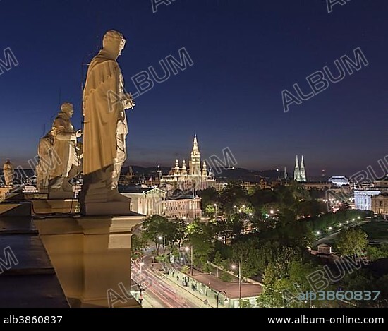 Statues of famous scientists on the roof of the Natural History Museum at night, view of Parliament and the City Hall, Vienna, Austria, Europe.