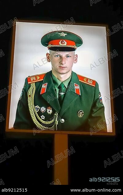 Illuminated photograph of a Soviet soldier at Checkpoint Charlie in Berlin.