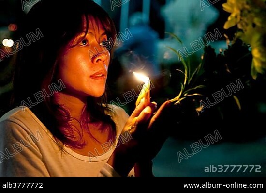 Young woman praying, Magha Puja holiday, Wat Pho Chai, Nong Khai, Isan, Thailand, Asia.