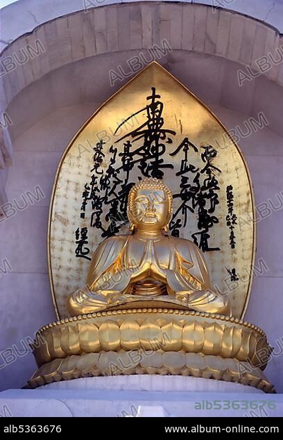 Gilded statue of Buddha on Vishwa Shanti Stupa, Rajgir, Bihar, India, Asia.