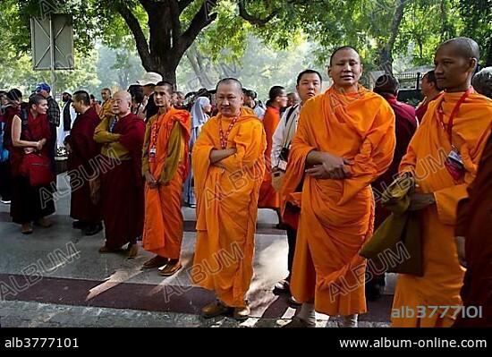 Monks wearing red and orange robes and Buddhist dignitaries from Laos, Burma, Myanmar, Cambodia, Korea, Tibet from all Buddhist traditions and schools at a meeting for communal prayer, Global Buddhist Congregation 2011, Gandhi Smitri, New Delhi, India, Asia.