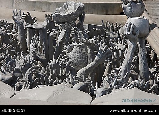 Arms of the damned emerging from the ground, white temple, Wat Rong Khun by the artist Chalermchai Kositpipat in Chiang Rai, northern Thailand, Thailand, Asia.