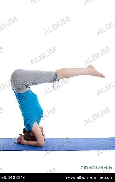 Yoga, young beautiful woman yoga instructor doing Lowered Bound Headstand (Salamba sirsasana with Urdhva Dandasana) exercise isolated on white background.
