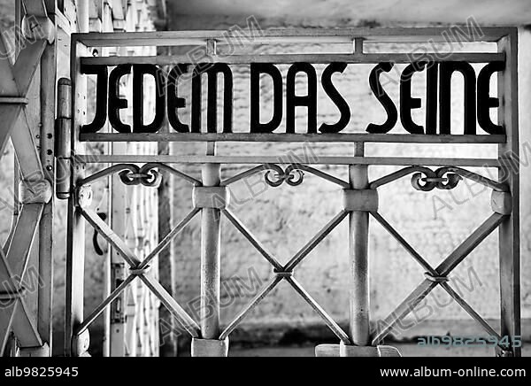 Entrance gate to beech forest concentration camp with the saying JEDEM DAS SEINE in Bauhaus script by Franz Ehrlich; former beech forest concentration camp; today a memorial; black and white; Weimar; Thuringia; Germany; Europe.