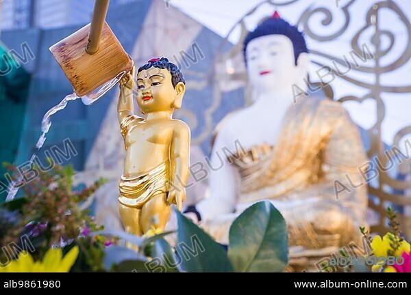 Bathing of a golden statue of the Buddha. The bathing of Buddha statues is a traditional wish ceremony in Buddhism on Buddha#39, s birthday.