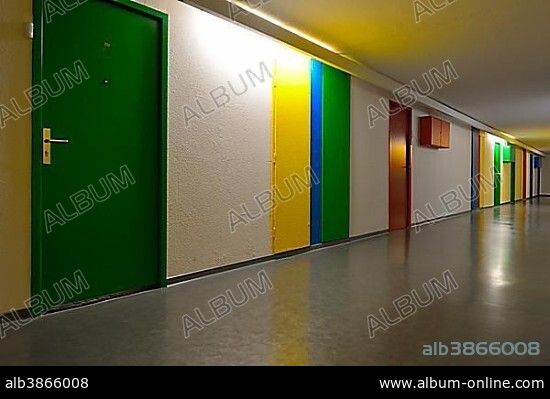 Hallway with colorful doors, Unité d'habitation de Briey, designed by Le Corbusier, modernist residential housing, UNESCO World Heritage Site, Briey, Meurthe-et-Moselle, Lorraine, France, Europe.