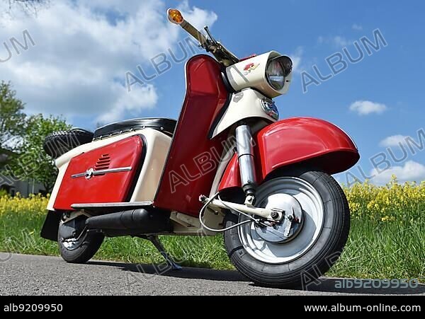 Touring scooter, motorbike troll from the GDR in front of a rape field, Germany, Europe.
