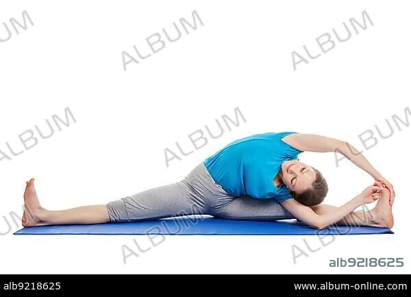 Yoga, young beautiful slender woman yoga instructor doing Revolved Wide Seated Forward Bend Pose (parivrtta upavistha konasana) asana exercise isolated on white background.