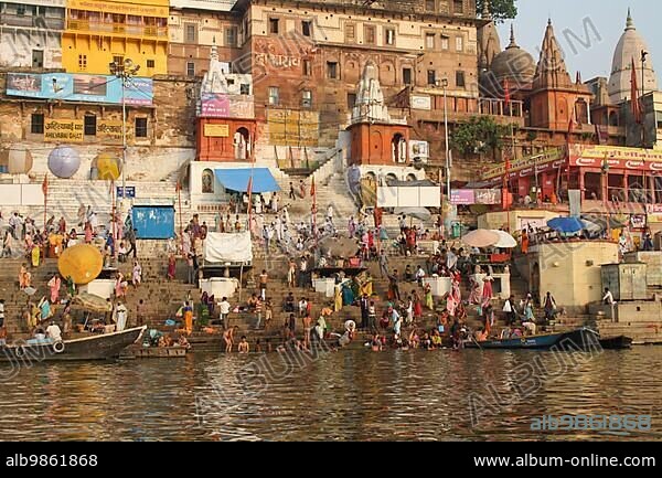 Varanasi, India, April 2, 2011: Hindu pilgrims take holy bath in the river ganges at colorful Ghats, Asia.