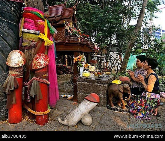 Women praying at the phallic shrine, Chao Mae Tuptim, penises carved in wood, offerings, fertility, Bangkok, Central Thailand, Thailand, Asia.