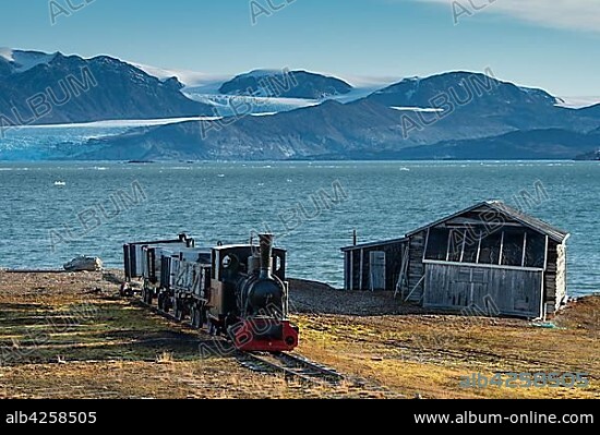 Historic mine train in front of the Kongsfjorden, Ny-Alesund, Spitsbergen, Svalbard Islands, Svalbard and Jan Mayen, Norway, Europe.