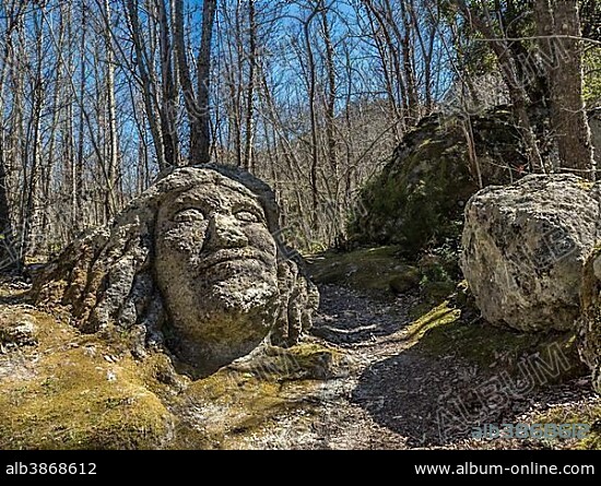 Large face made of tufa in the forest Falanga, Ischia, Calabria, Italy, Europe.