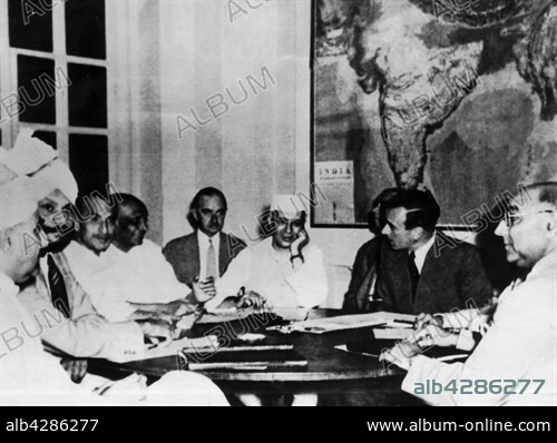 A view of the conference where the viceroy of India, Lord Mountbatten, exposed the plan of June, 2 1947 concerning the transfer of power to Indians.. On the picture: Lord Mountbatten speaking with Pandit Nehru (in the middle). On the l. (with a beard), . Sarda.. June 1947. India. National Archives - Washington.