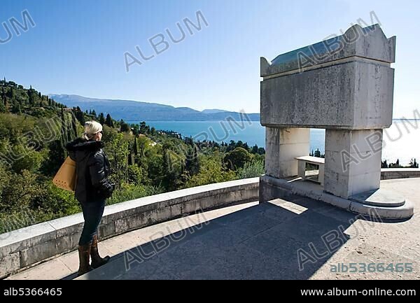 Woman looking onto Lake Garda from the Citadelle, the Mausoleum on the grounds of the Vittoriale degli Italiani, Italian victory monument, estate of the Italian poet Gabriele D'Annunzio, Gardone Riviera, Lake Garda, Italy, Europe.