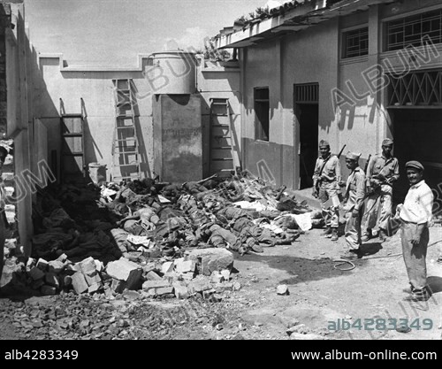 Colombian soldiers standing guard over bodies of victims of a dynamite blast in the city of Cali, Colombia, which took an estimated 1,800 lives.. August 1956.