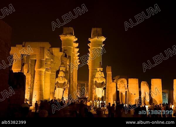 Great Court of Ramses II with the Colonnade of Amenhotep III located behind the two statues of Ramses, Luxor Temple at night, Luxor, Nile valley, Egypt, Africa.