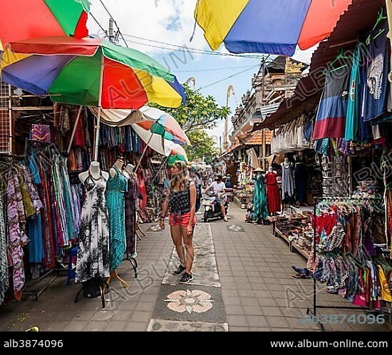 Female tourist looks at dresses, Traditional Art Market, Ubud, Bali, Indonesia, Asia.
