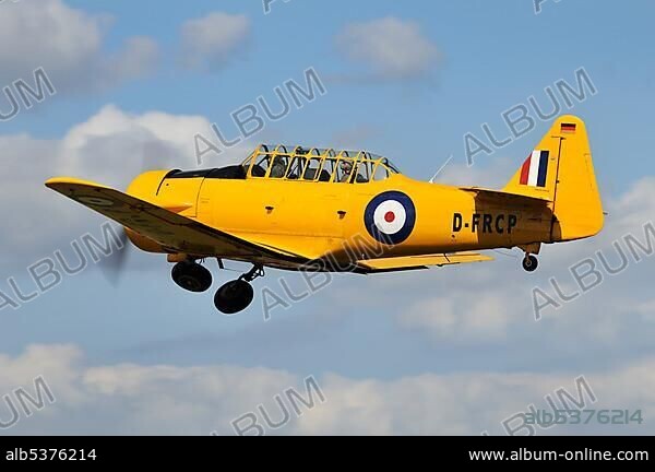 U.S. military trainer, North American T-6 Harvard immediately after take-off, Europe's largest meeting of vintage planes at Hahnweide, Kirchheim-Teck, Baden-Wuerttemberg, Germany, Europe.