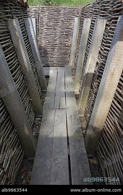 Reconstruction of German First World War One trench showing wooden duckboards and woven wickerwork branches at Zonnebeke, Belgium, Europe.