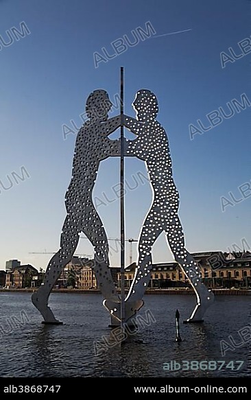 Molecule Men sculpture in the Spree river near the Treptowers high-rise buildings, Treptow district, Berlin, Germany, Europe.