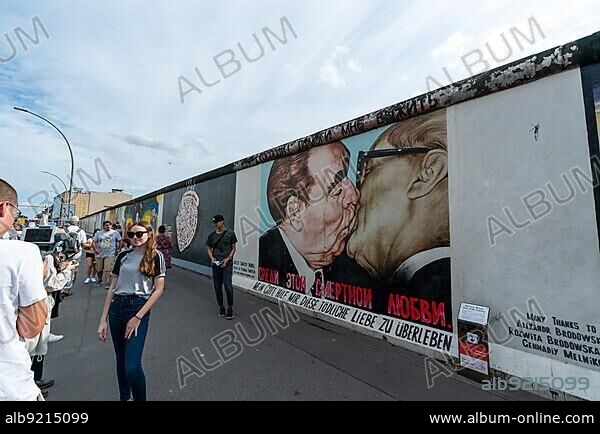 Berlin, Germany - 25 August 2020: tourists take photographs of themselves at the Berlin Wall East Side Gallery.