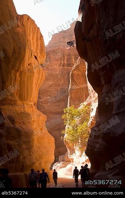 Tourists walking through the Siq, Petra, Jordan, Southwest Asia, Asia.