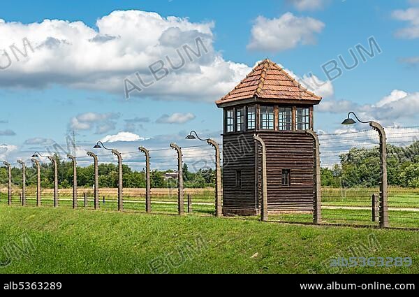 Barbed-wire fence and watch-tower at Auschwitz II-Birkenau concentration camp, Oswiecim, Poland, Europe.
