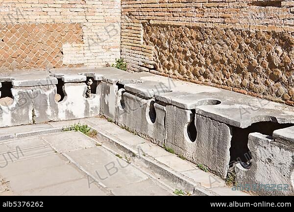 Ancient public toilets at Ostia Antica archaeological site, Rome, Italy, Europe.