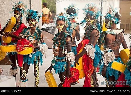Colourfully painted actors in traditional costume at the Dinagyang Folk Festival in the Cultural Centre of the Philippines, Manila, Philippines, Asia.